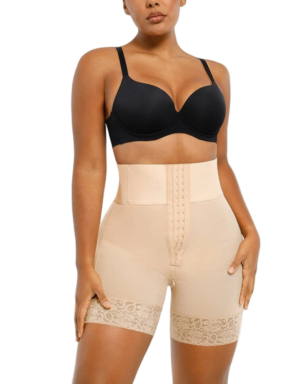 Woman wearing a black bra and beige shapewear on a white background