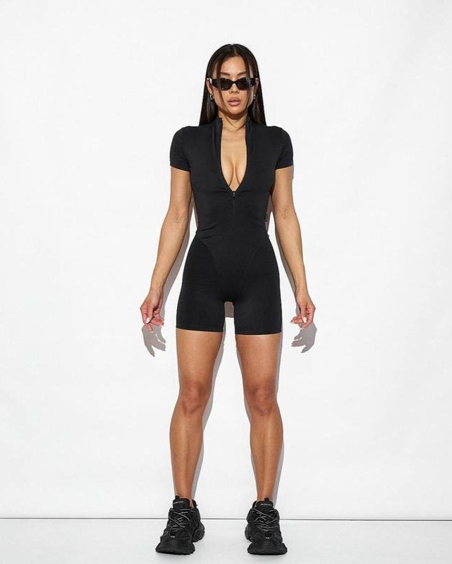 Person wearing a black bodysuit on a white background