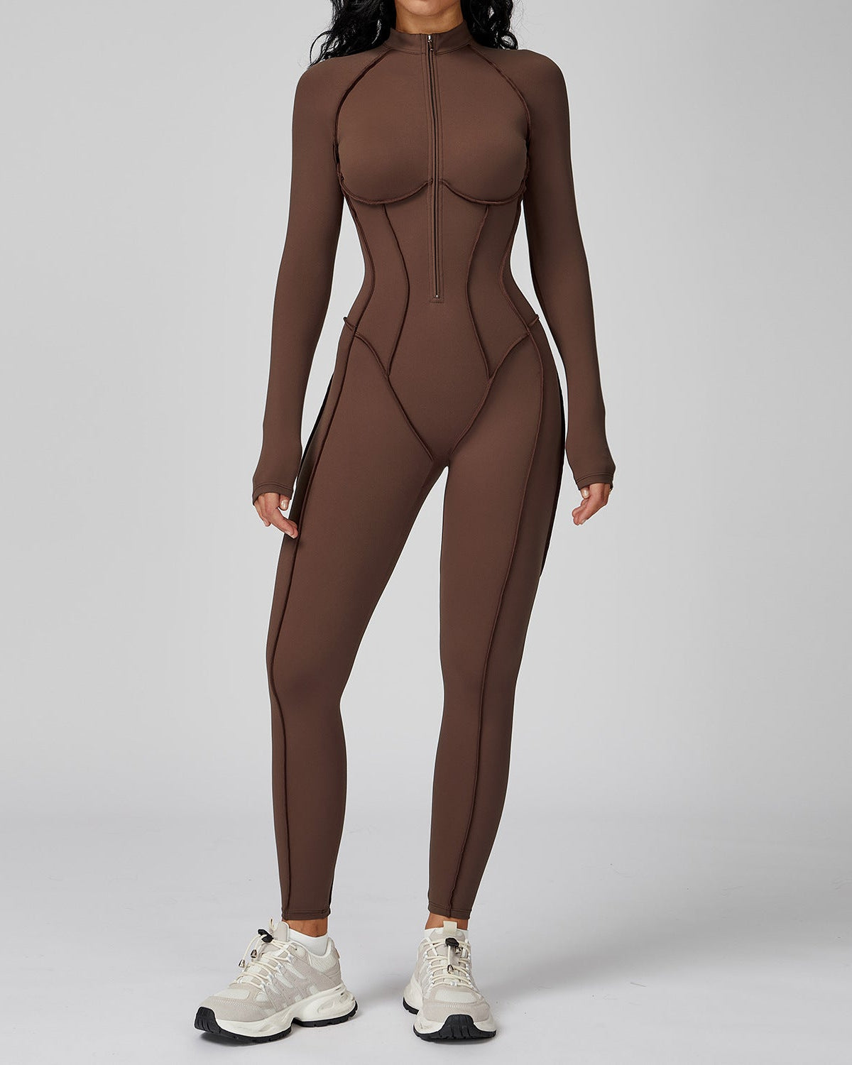 Brown bodysuit worn by a person on a gray background