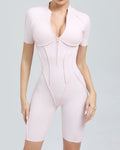 Pink shapewear bodysuit on a gray background