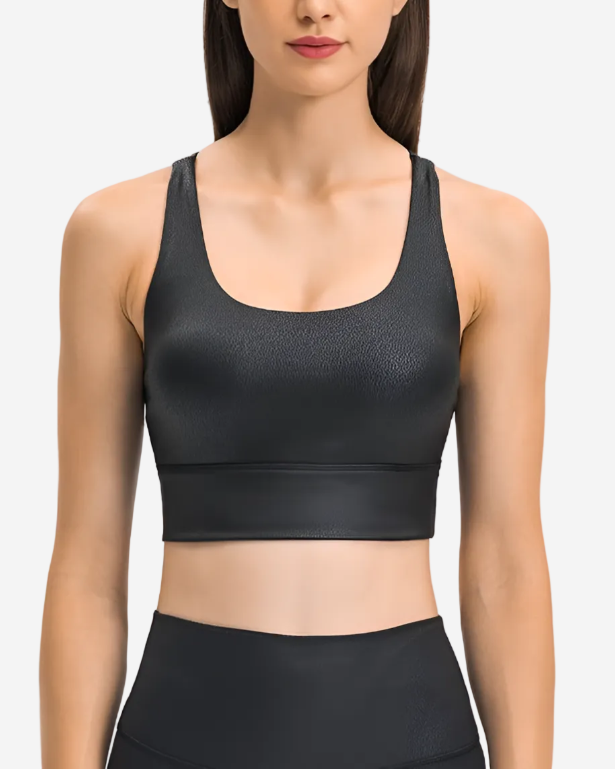 Black sports bra worn by a model on a light gray background