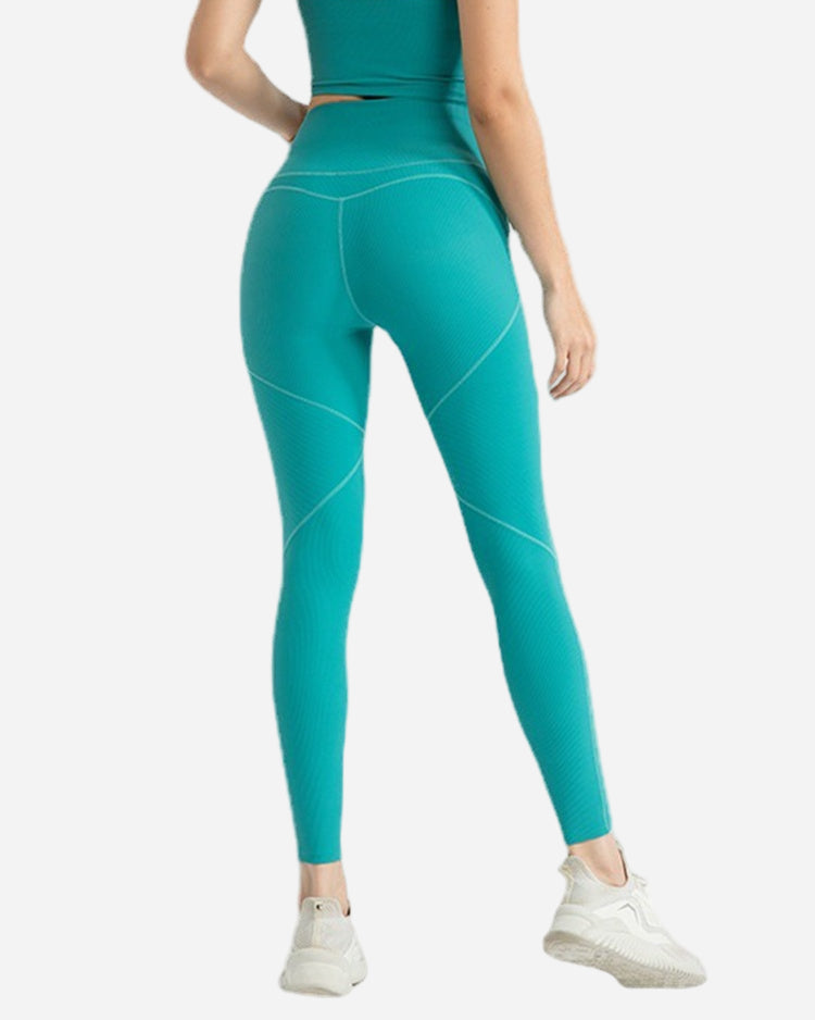 Teal leggings worn by a person on a white background