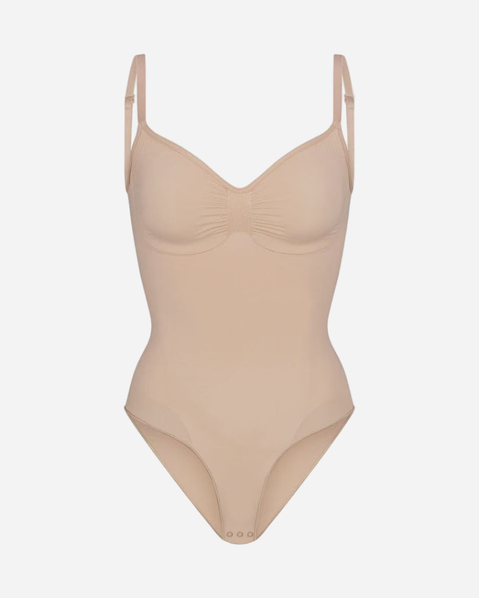 Beige swimsuit with thin straps on a white background